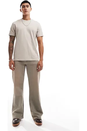 ASOS – Weite Schlagjeans in heller Waschung mit Farbstich