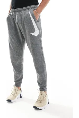Nike – Swoosh – Schmal zulaufende Jogginghose in Grau mit Print