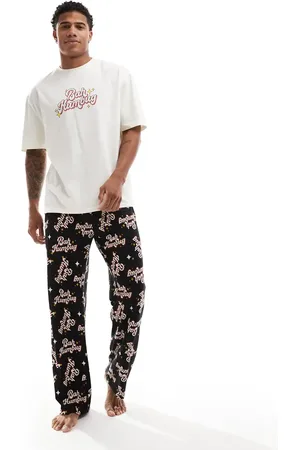 ASOS – Pyjama in Schwarz mit „Bah Humbug“-Slogan