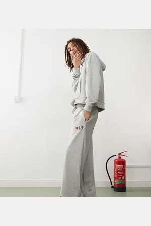 COLLUSION – Oversize-Jogginghose in meliertem mit Bündchen und burgunderrotem Print