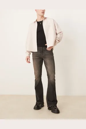 ASOS – Elastische Schlagjeans in verwaschenem mit braunem Farbstich