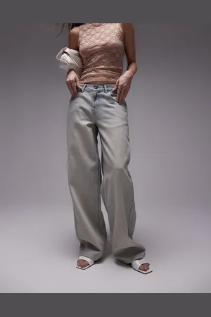 Topshop – Jeans in Vintage-Bleach-Waschung mit niedrigem Bund und Schnallenriemen