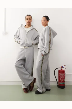 Reclaimed – Weit geschnittene Unisex-Jogginghose in meliert mit karierten Seitenstreifen