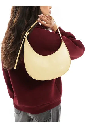 ASOS – Halbmondförmige Schultertasche in Buttermilch mit asymmetrischem Design und Schnalle