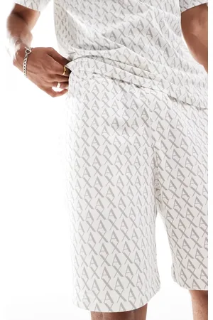 Armani Exchange – Jersey-Shorts in mit durchgehendem Logo-Print, Kombiteil