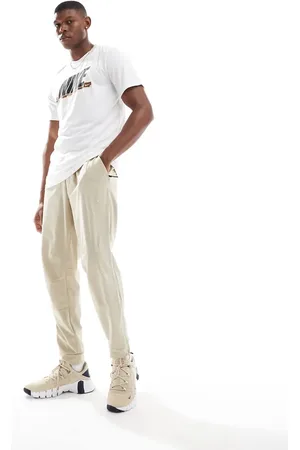 Nike – Unlimited Dri-FIT – Trainingshose in Beige