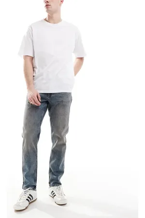 River Island – Schmal zulaufende Jeans in verwaschenem Mittelblau