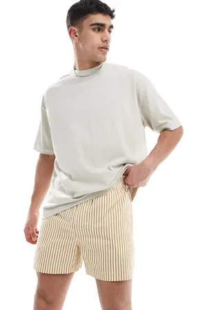 ASOS – Kurz und weit geschnittene Shorts mit Streifen in Gelb und Weiß