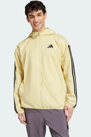 adidas Essentials – Windjacke in Powder Yellow / Schwarz mit den 3 Streifen