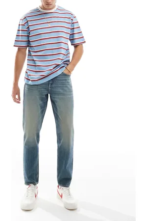 ASOS – Schmal zulaufende Jeans in verwaschenem Mittelblau mit Vintage-Farbstich