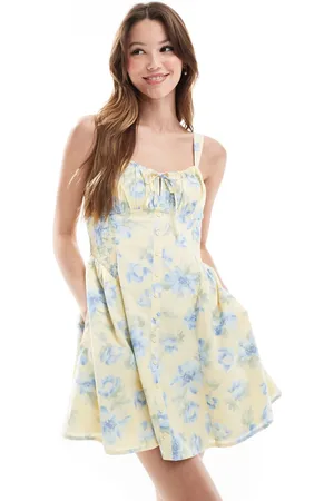 Hollister – Ärmelloses Minikleid in mit Milchmädchen-Ausschnitt, tiefer Taille, Knopfdetail und Blumenmuster