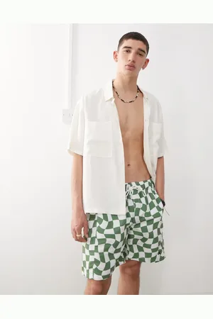 COLLUSION – Bade-Boardshorts in Khaki mit Schachbrettmuster
