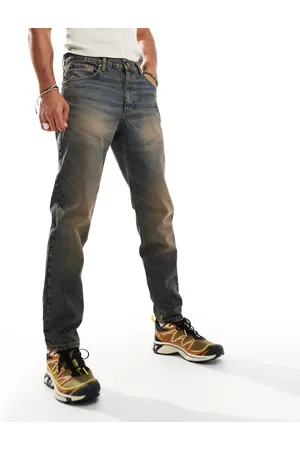 ASOS – Schmal zulaufende Jeans in blauer Waschung mit Farbstich