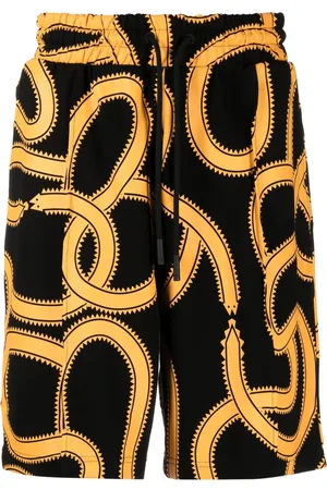 MARCELO BURLON Snakes print track shorts