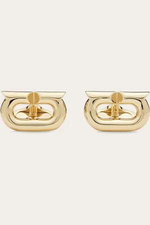 Salvatore Ferragamo Manschettenknöpfe aus goldfarbenem Messing, mit frontalem Element, das durch die neue Gancini-Silhouette geprägt ist, die ein wenig länglicher und graphischer ist